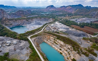 Aerial view of opencast mining quarry with lots of machinery at work - view from above.