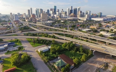 Aerial view of a city skyline with multiple highway overpasses
