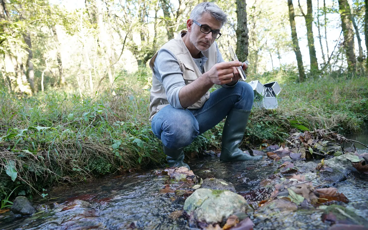 male biologist taking water sample