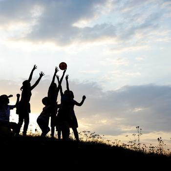 silhouette of kids playing ball
