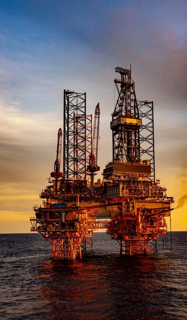 oil drilling rig at sunset