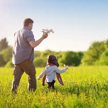 Father playing with his daughter in a farm