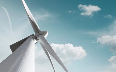 Wind turbine against blue sky