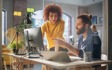 Female Manager and Specialist working Behind a Desk