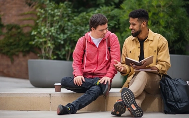 Two men talking on a stair