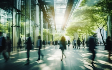 blurred people in a green corporate building
