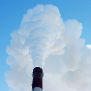 Smoking stack of thermal power station against a blue sky