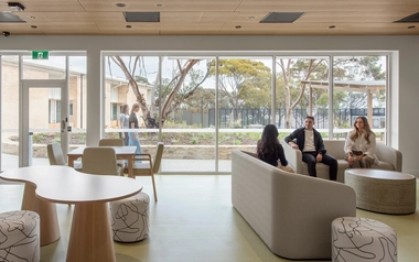  Lounge with chairs and sofas facing large windows