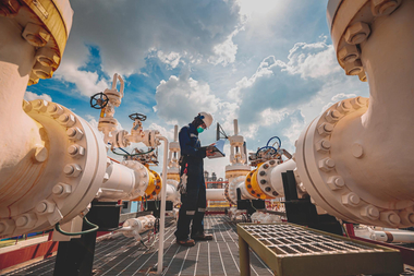 personnel inspecting steel pipes
