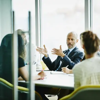 Getty Image_640127001_Mature businessman leading meeting in office